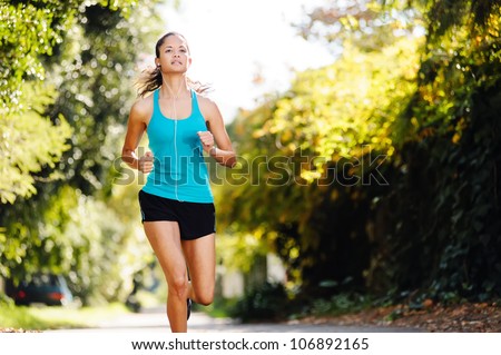running healthy fitness woman training for marathon outdoors in alleyway. vitality lifestyle exercise athlete.