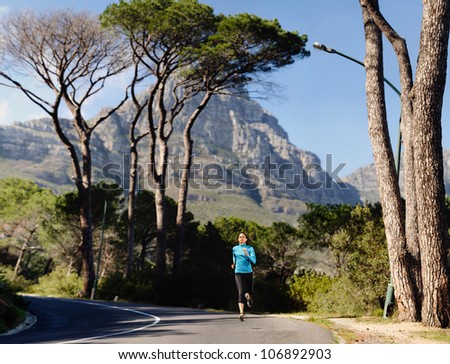Fitness athlete training alone on a mountain road. Running endurance marathon woman exercising for healthy lifestyle and wellness. panorama with copyspace XXL