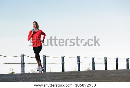 Athletic runner training alone on a road outdoors for marathon and fitness. healthy wellness exercise panorama with copyspace.
