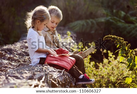 young children playing outdoors, happy brother and sister having fun