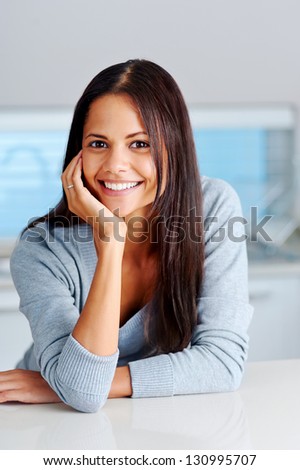 portrait of beautiful woman at home in kitchen lifestyle leaning on hand
