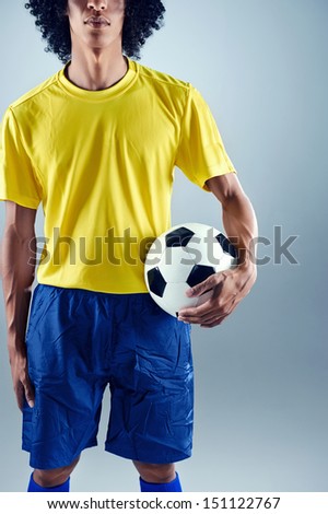 Portrait of Brazilian soccer football player with ball and national kit ready for the world cup