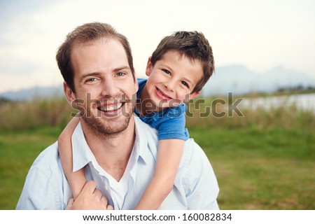 Happy father and son portrait playing together having fun