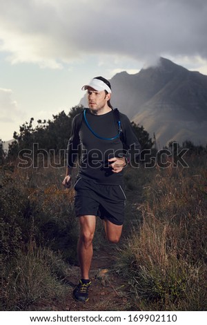 Ultra marathon trail runner with determintion exercising for fitness and healthy lifestyle