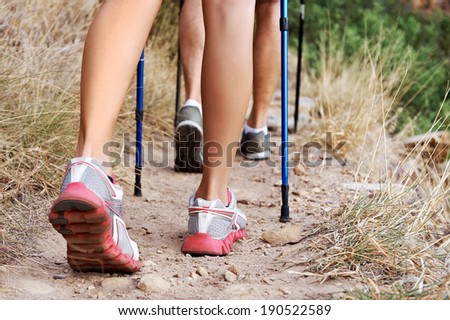 Close up of people walking along a hiking trail