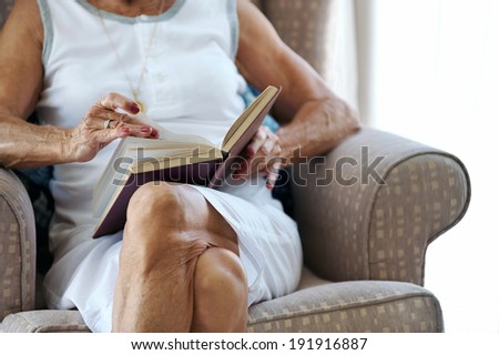 elderly woman reading her book hands anonymous