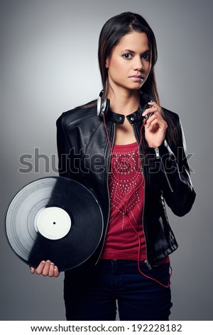 Woman dj portrait with vinyl record and headphones