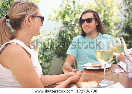 Couple drinking white wine at lunch while on summer vacation