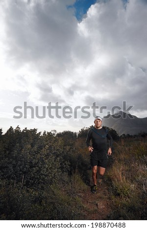 Ultra marathon trail runner with determination exercising for fitness and healthy lifestyle