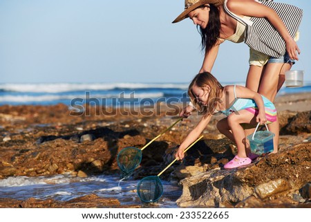 Mother and daughter spend the day fishing at the beach together having fun and bonding over some quality parent childhood time Stock foto © 