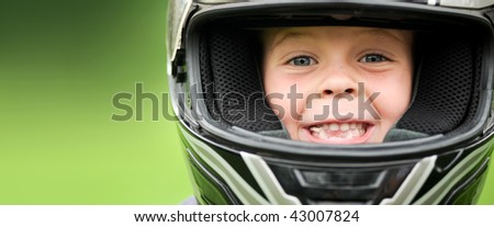 Child with motorbike helmet, safety concept