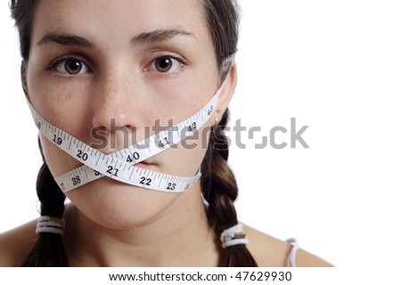 Dieting concept, cute girl had her mouth closed by measuring tape.