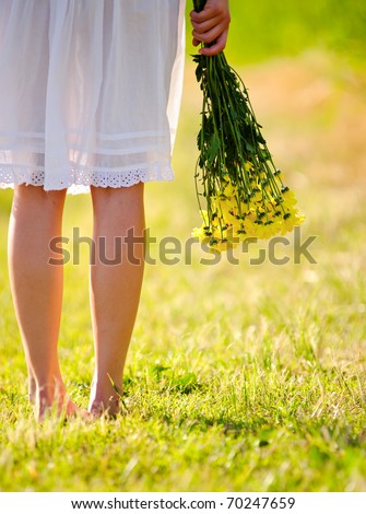White dress with flowers in hand, spring time concept