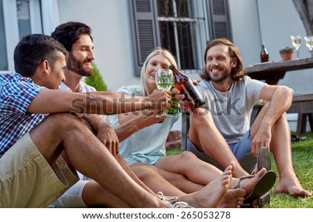 happy smiling diverse group of friends having outdoor garden party with beer wine drinks