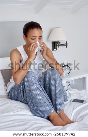 depressed sad sick young woman with tissues at home bedroom