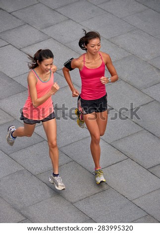 active asian chinese sporty women training outdoors for marathon run in morning