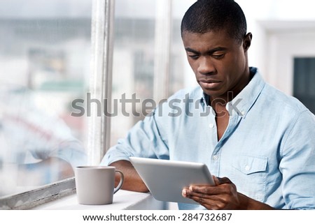 black african businessman with tablet and coffee