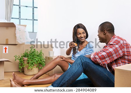 young black couple celebrating their new apartment and passing key
