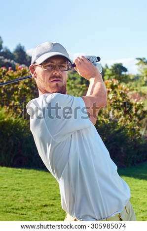 golfer hitting driver club on course for tee shot