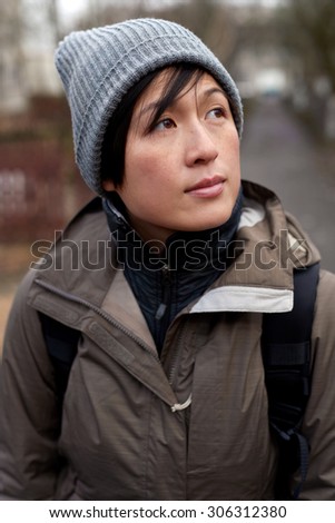 Portrait of young asian chinese woman warmly dressed