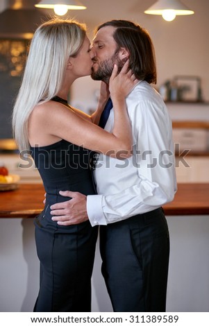 romantic affectionate young couple morning kissing goodbye for work at home