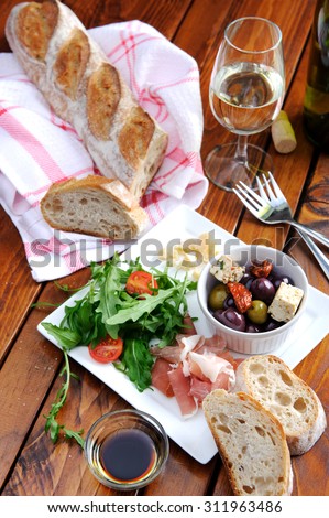 Romantic dinner for two; italian antipasto platter with parma ham, rocket, olives, baguette and wine