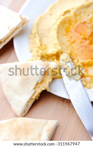 Plate with hummus dip and pita bread, a common tapas or starter dish in middle eastern cuisine