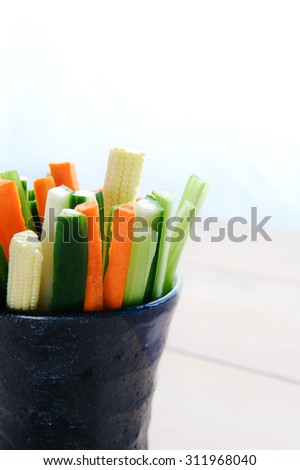 Ready to eat raw sticks of carrot, cucumber, corn and celery in a cup