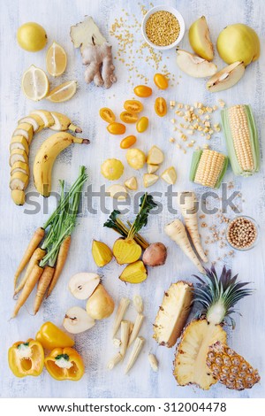 Assorted fresh raw organic produce in yellow hues, pepper capsicum carrot pineapple corn banana parsnip pear soya beans lentils quince, part of a color spectrum collection see more in my portfolio