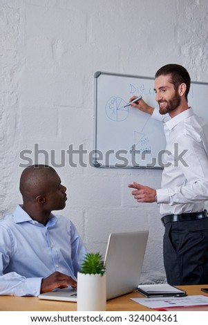 professional businessman writing new startup business ideas on glass presentation board in modern office