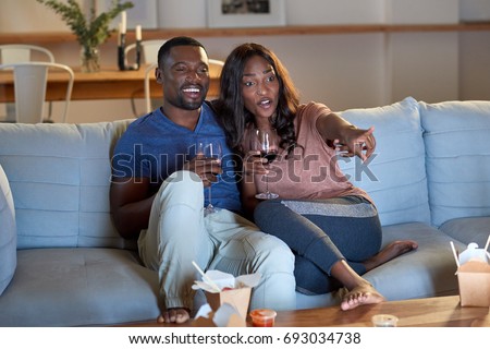 https://image.shutterstock.com/display_pic_with_logo/239779/693034738/stock-photo-black-african-couple-watching-movie-television-together-having-date-night-693034738.jpg