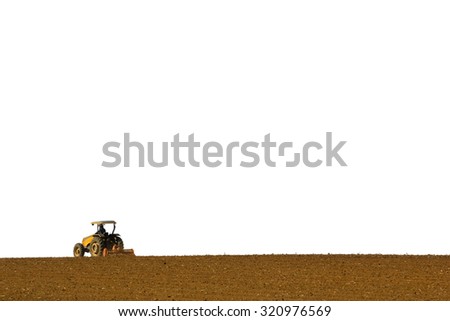 Yellow tractor driven by a farm preparing the soil for planting and white background