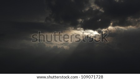 Dark clouds covered the sun, beautiful light from the clouds injection.