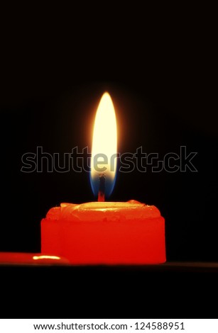 White candles, on a black background, dazzling flashing light.