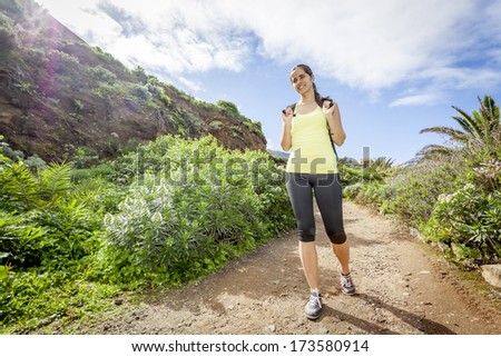 young woman hiking happy in tropical nature