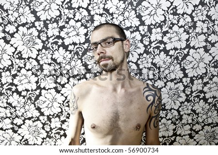 skinny tattoo guy on floral background