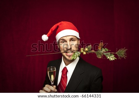 young funny guy with christmas hat on red velvet background