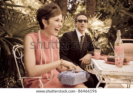 retro sixties style fashion couple having breakfast outdoor