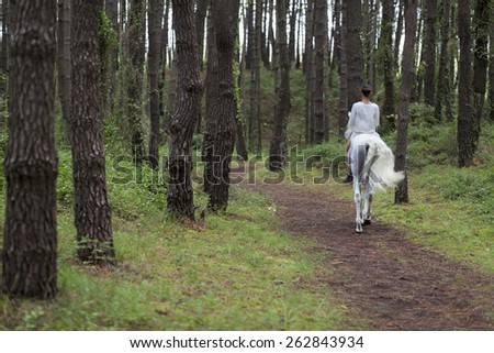 GIRL WALKING ON A WHITE HORSE
