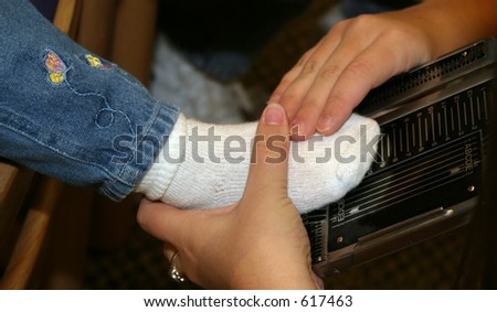 measuring a child's foot for shoe size