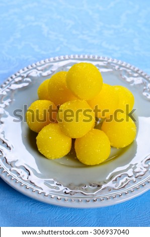 Yellow candy in sugar, round shape. Selective focus.