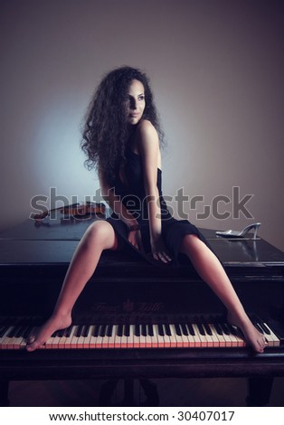 Young and beautiful girl feel the passion of  love with music of a grand piano in background