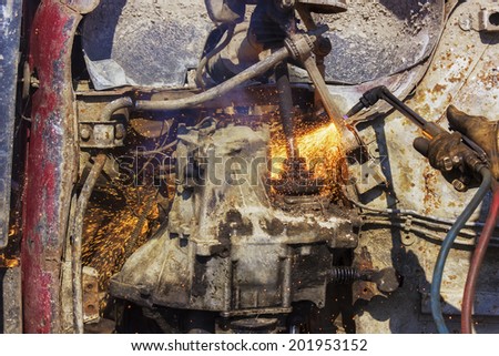 Old car motor flame cutting.