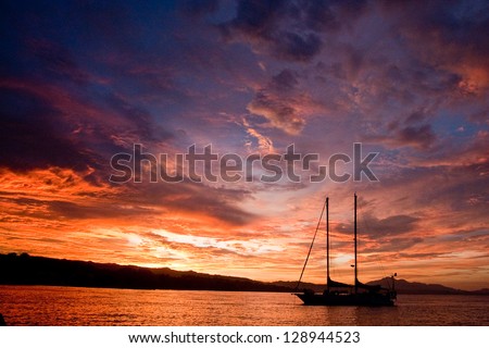 Schooner at anchor on Guadalcanal Island in Solomon Islands in South Pacific at sunset