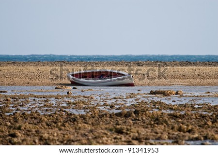 Fishing boat beached on tidal flat in Rodrigues, Indian Ocean