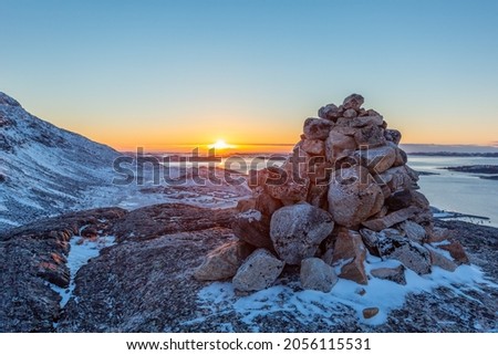 Polar arctic greenlandic sunset over the Nuuk fjord and stone pyramid, Nuuk, Greenland