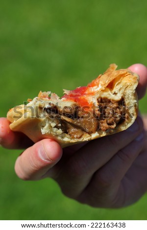 Meat Pie, A man eating an unhealthy pie with sauce.