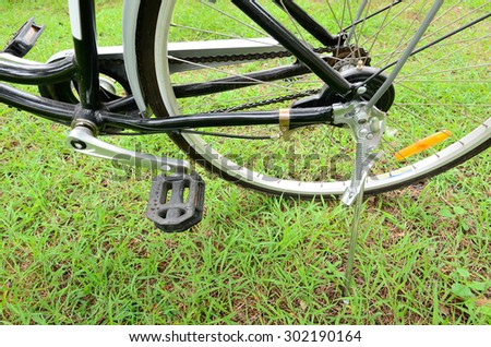 Parked bicycle using stand in the park