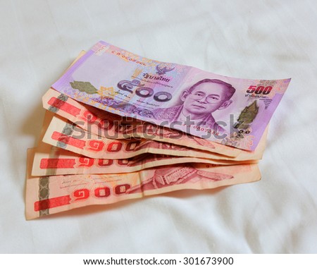 Thai bank note and Thai bank note on the bed sheet