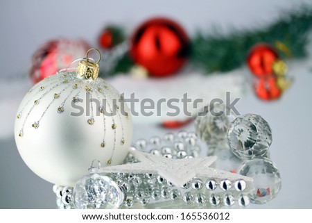 Christmas baubles, Cristal sphere and star on silver background with reflections